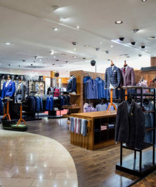 Interior of a high-quality clothing shop for men with many suits and neckties on display